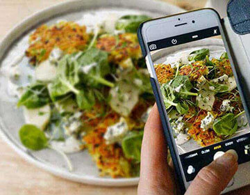 Alpro phone taking picture of veggie meal